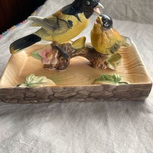 Midcentury Tilso Japan orioles perched on beach like base.